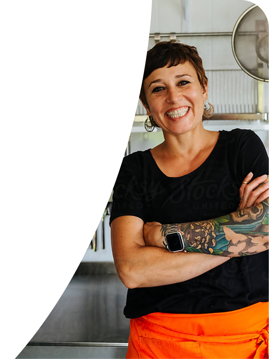 Smiling small-business owner with arms crossed